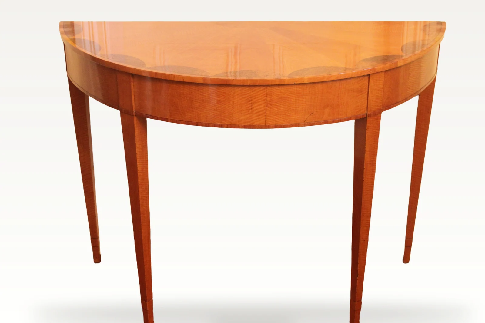 An early 19th century satinwood demi-lune console table